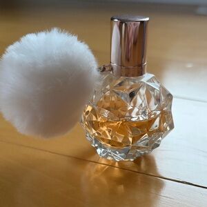 Ari by Ariana Grande Perfume with White Pom Pom. About 3/4 full. 3.4 oz bottle.